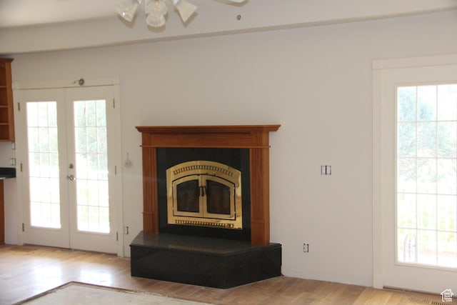 1627 W 950 S, Parowan, UT 84761 - unfurnished living room with french doors, a glass covered fireplace, ceiling fan, and wood finished floors