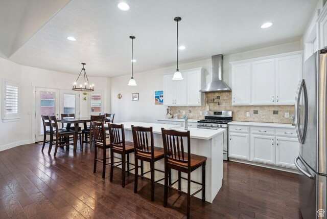 967 W Yamada Ct S, Syracuse, UT 84075 - kitchen featuring wall chimney exhaust hood, stainless steel appliances, light countertops, tasteful backsplash, and white cabinetry