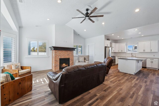967 W Yamada Ct S, Syracuse, UT 84075 - living area featuring ceiling fan, a fireplace, dark wood finished floors, recessed lighting, and high vaulted ceiling