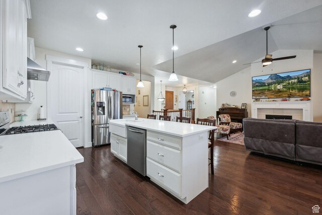 967 W Yamada Ct S, Syracuse, UT 84075 - kitchen with stainless steel appliances, a kitchen bar, ceiling fan, open floor plan, and white cabinetry