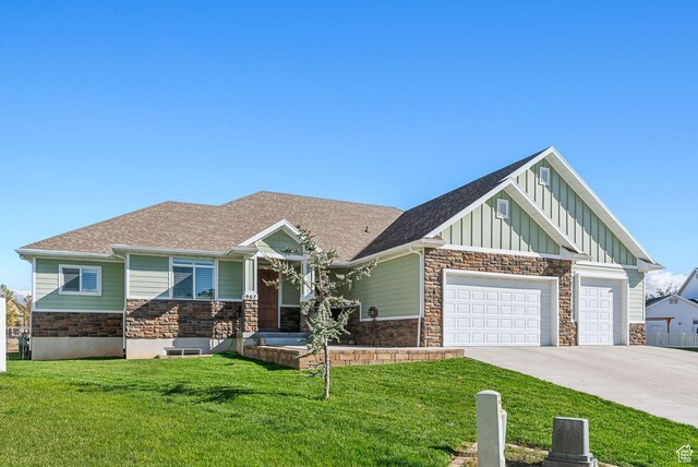 967 W Yamada Ct S, Syracuse, UT 84075 - craftsman-style house with board and batten siding, stone siding, driveway, a front yard, and an attached garage