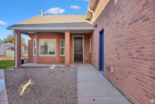 967 W Yamada Ct S, Syracuse, UT 84075 - view of exterior entry with brick siding and roof with shingles