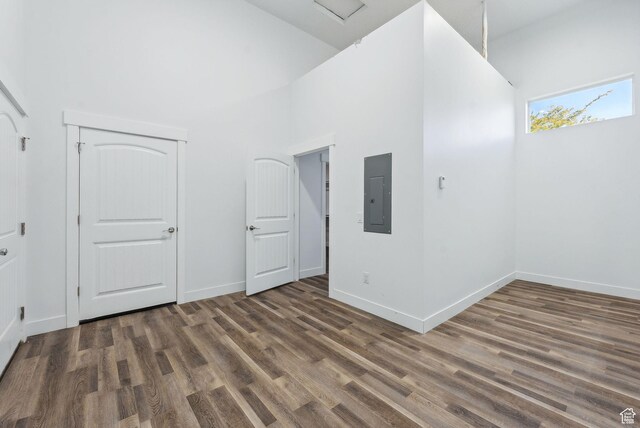 967 W Yamada Ct S, Syracuse, UT 84075 - empty room with electric panel, a high ceiling, and wood finished floors