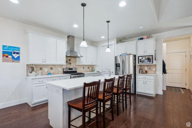 967 W Yamada Ct S, Syracuse, UT 84075 - kitchen with wall chimney exhaust hood, stainless steel appliances, light countertops, dark wood-style flooring, and tasteful backsplash