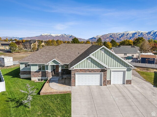 967 W Yamada Ct S, Syracuse, UT 84075 - craftsman-style home with board and batten siding, concrete driveway, a garage, a front yard, and a mountain view