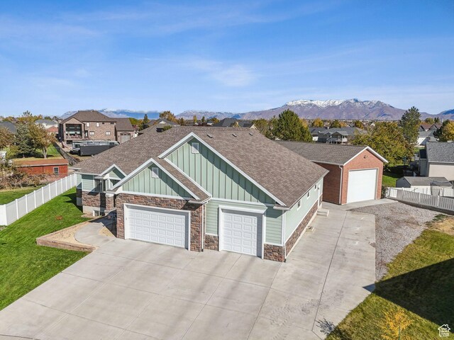 967 W Yamada Ct S, Syracuse, UT 84075 - view of front of house featuring board and batten siding, stone siding, a shingled roof, concrete driveway, and a residential view