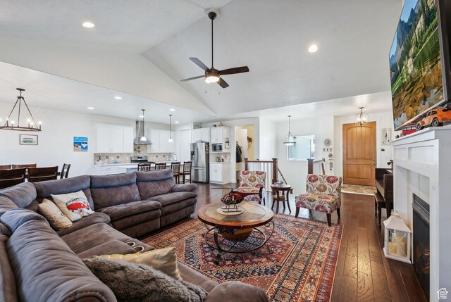 967 W Yamada Ct S, Syracuse, UT 84075 - living room featuring dark wood-type flooring, a ceiling fan, a chandelier, high vaulted ceiling, and a fireplace