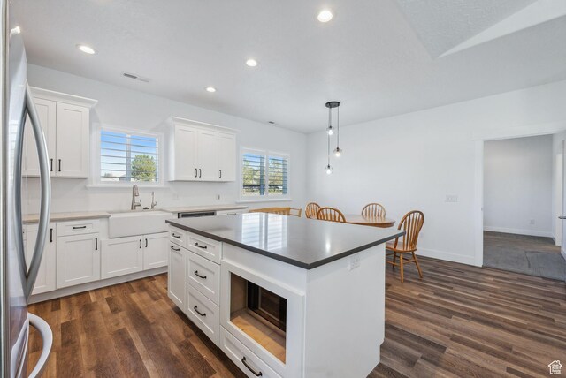 967 W Yamada Ct S, Syracuse, UT 84075 - kitchen featuring freestanding refrigerator, dark wood finished floors, white cabinets, a center island, and recessed lighting