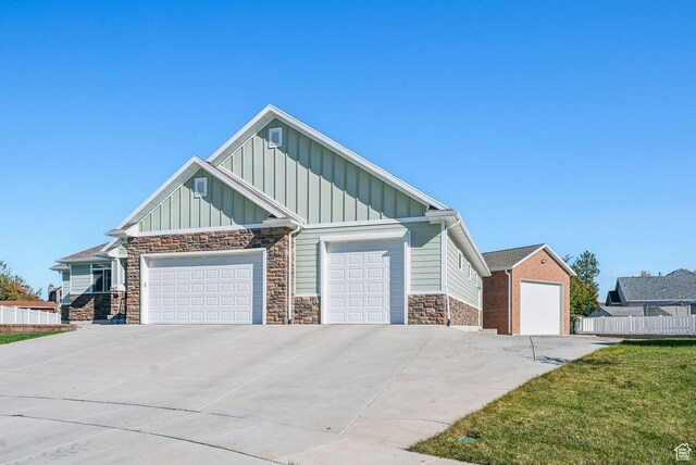 967 W Yamada Ct S, Syracuse, UT 84075 - view of front of property with board and batten siding, stone siding, an attached garage, and driveway