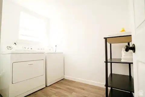 1065 E 22nd St, Ogden, UT 84401 - laundry area featuring washer and clothes dryer, light wood finished floors, and baseboards
