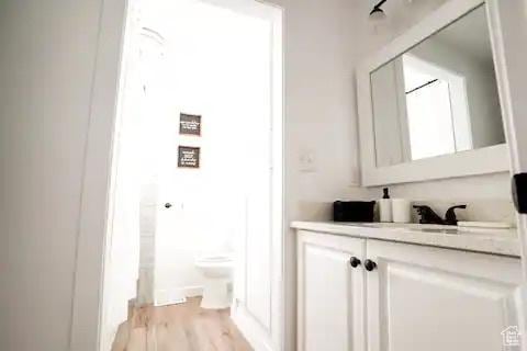 1065 E 22nd St, Ogden, UT 84401 - bathroom with vanity, toilet, and wood finished floors