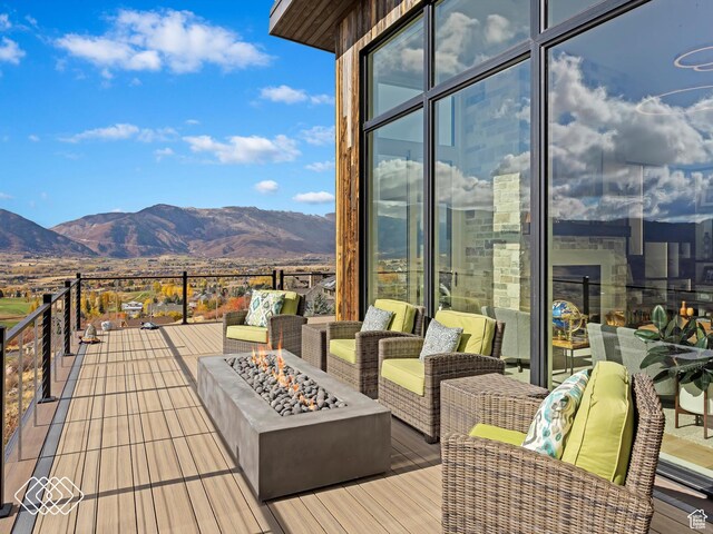 5731 E Porcupine Ridge Dr N, Eden, UT 84310 - deck with an outdoor fire pit and a mountain view