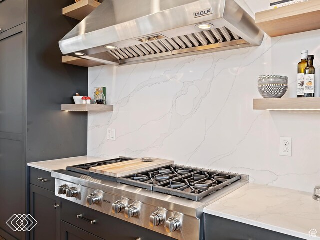 5731 E Porcupine Ridge Dr N, Eden, UT 84310 - kitchen featuring ventilation hood, stainless steel gas cooktop, open shelves, tasteful backsplash, and light stone countertops