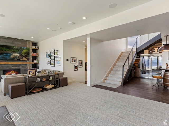 living room featuring dark hardwood / wood-style flooring and a fireplace