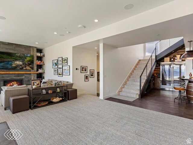 5731 E Porcupine Ridge Dr N, Eden, UT 84310 - carpeted living area with stairs, a stone fireplace, recessed lighting, and baseboards