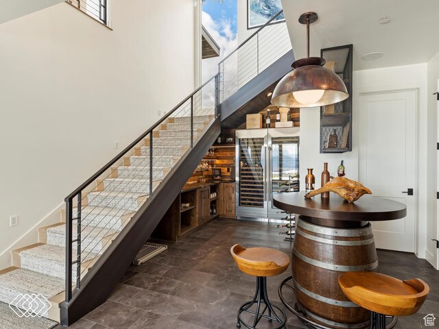 5731 E Porcupine Ridge Dr N, Eden, UT 84310 - stairs featuring healthy amount of natural light, a towering ceiling, and beverage cooler