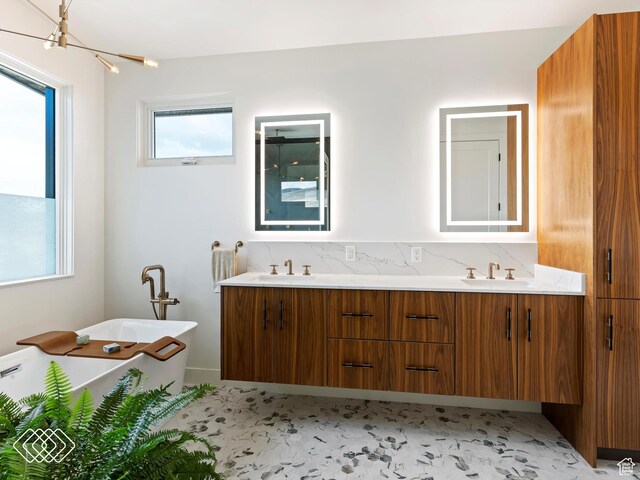 5731 E Porcupine Ridge Dr N, Eden, UT 84310 - bathroom with double vanity, a freestanding bath, and decorative backsplash
