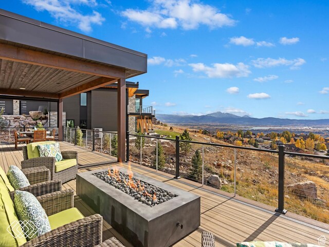 5731 E Porcupine Ridge Dr N, Eden, UT 84310 - wooden terrace featuring a fire pit and a mountain view