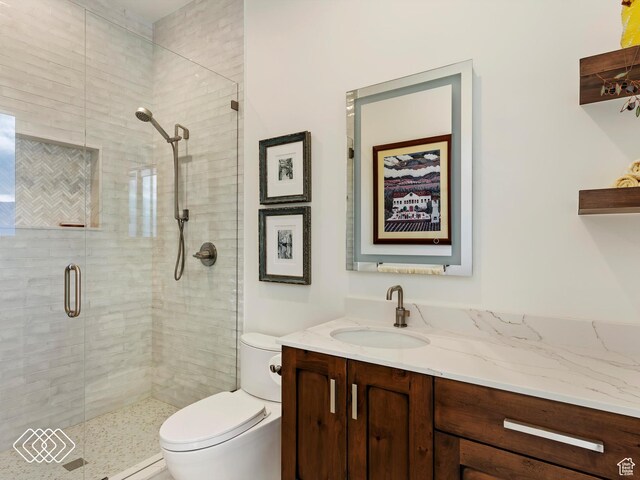 5731 E Porcupine Ridge Dr N, Eden, UT 84310 - bathroom featuring toilet, vanity, and a stall shower