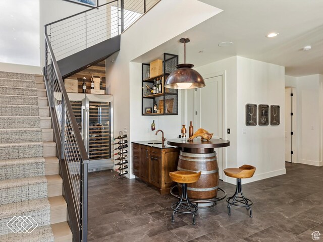 5731 E Porcupine Ridge Dr N, Eden, UT 84310 - indoor wet bar with beverage cooler, stairs, pendant lighting, and baseboards