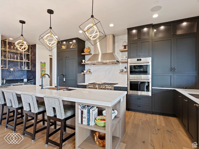 5731 E Porcupine Ridge Dr N, Eden, UT 84310 - kitchen featuring open shelves, appliances with stainless steel finishes, a sink, tasteful backsplash, and wall chimney exhaust hood