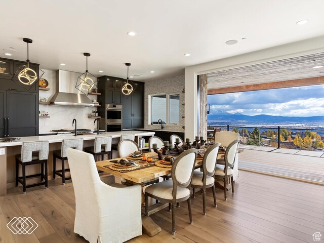 5731 E Porcupine Ridge Dr N, Eden, UT 84310 - dining area featuring light wood-style flooring, a mountain view, and recessed lighting