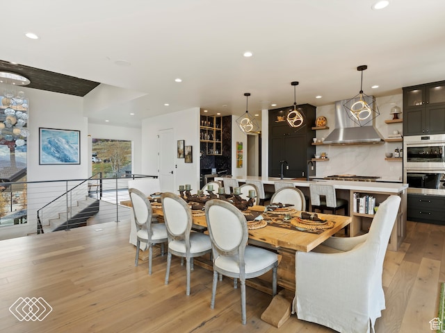 dining room featuring light wood-type flooring, a wealth of natural light, and sink