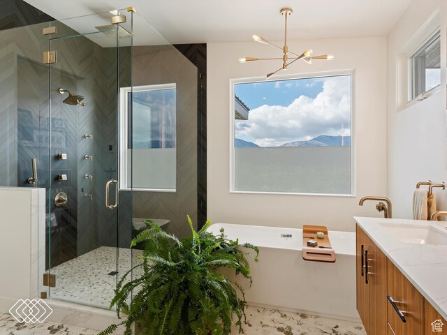 5731 E Porcupine Ridge Dr N, Eden, UT 84310 - bathroom with a soaking tub, a stall shower, a chandelier, and vanity