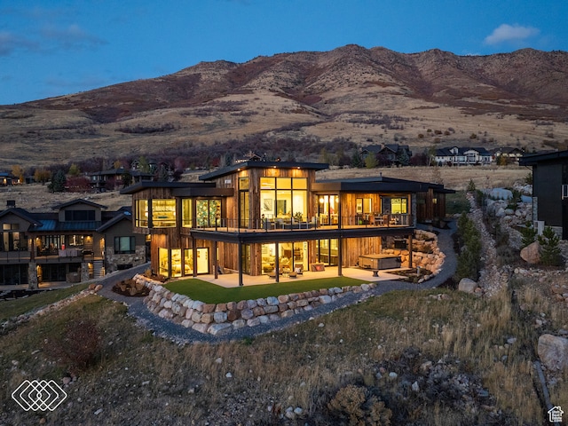 back of house with a balcony and a mountain view