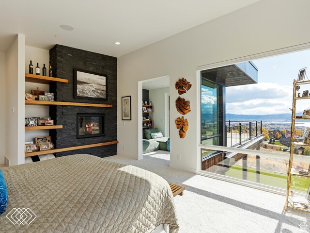 5731 E Porcupine Ridge Dr N, Eden, UT 84310 - bedroom with a large fireplace, carpet floors, and access to exterior