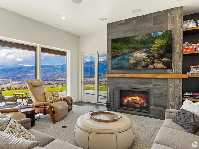 5731 E Porcupine Ridge Dr N, Eden, UT 84310 - living area featuring a mountain view, a tiled fireplace, and recessed lighting