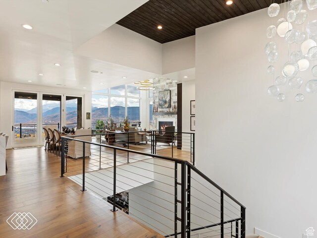 5731 E Porcupine Ridge Dr N, Eden, UT 84310 - hallway featuring an upstairs landing, recessed lighting, wood finished floors, a mountain view, and a high ceiling