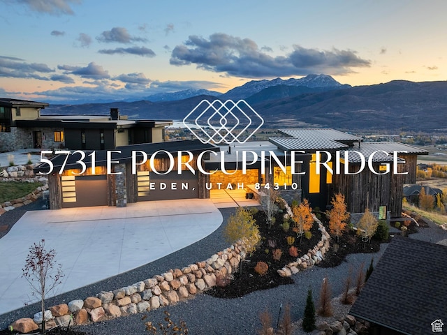 5731 E Porcupine Ridge Dr N, Eden, UT 84310 - view of front of home featuring a mountain view, concrete driveway, and a garage