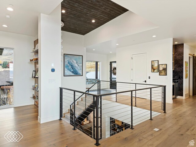 5731 E Porcupine Ridge Dr N, Eden, UT 84310 - hall featuring an upstairs landing, wood-type flooring, recessed lighting, and baseboards