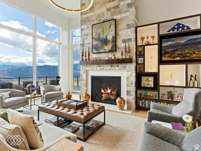 5731 E Porcupine Ridge Dr N, Eden, UT 84310 - living room featuring a mountain view, a stone fireplace, and wood finished floors