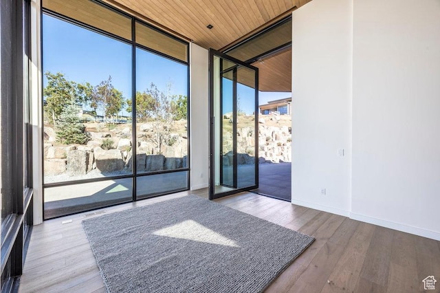 3821 Pinnacle Sky Loop, Park City, UT 84098 - unfurnished room with expansive windows, wooden ceiling, wood finished floors, and baseboards