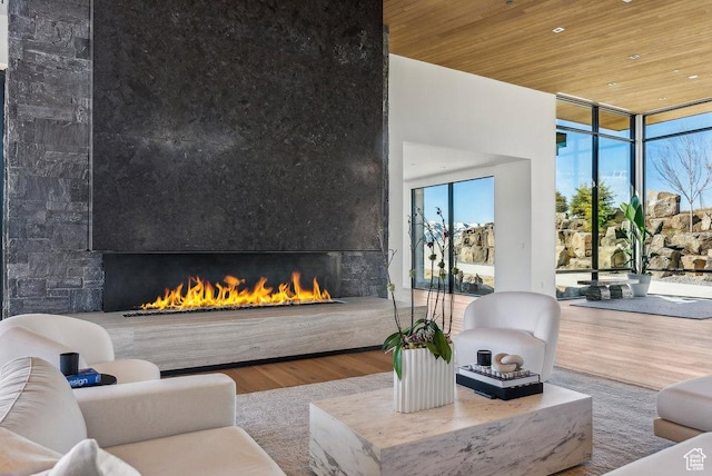 3821 Pinnacle Sky Loop, Park City, UT 84098 - living area with a fireplace, a wall of windows, wooden ceiling, and wood finished floors