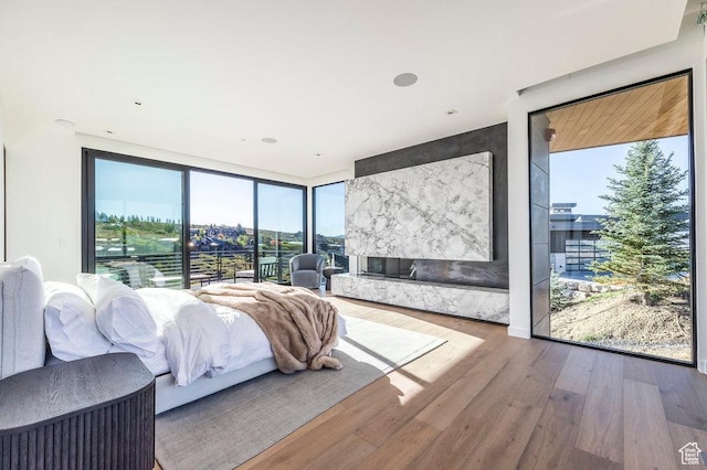 3821 Pinnacle Sky Loop, Park City, UT 84098 - bedroom featuring wood finished floors, multiple windows, a wall of windows, and access to exterior