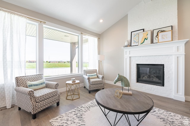 12751 S Harvest Ln W Unit 6, Riverton, UT 84096 - living room featuring baseboards, lofted ceiling, visible vents, and wood finished floors