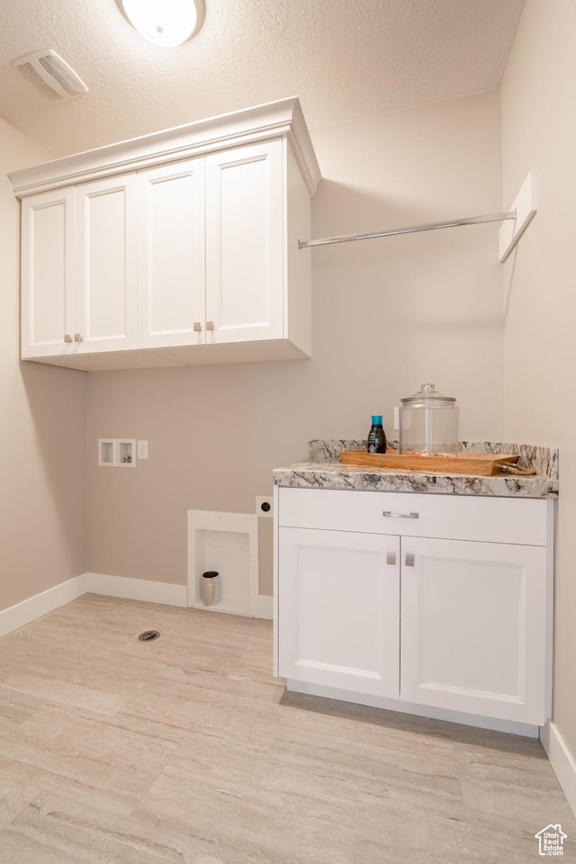 12751 S Harvest Ln W Unit 6, Riverton, UT 84096 - washroom featuring washer hookup, hookup for an electric dryer, baseboards, visible vents, and cabinet space