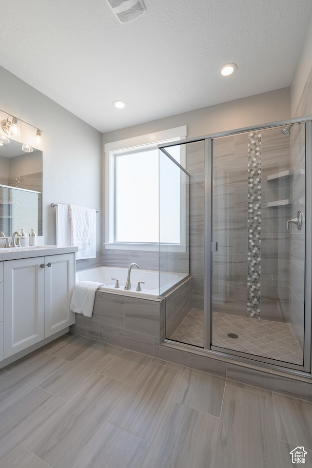12751 S Harvest Ln W Unit 6, Riverton, UT 84096 - bathroom featuring a shower stall, visible vents, vanity, and a garden tub