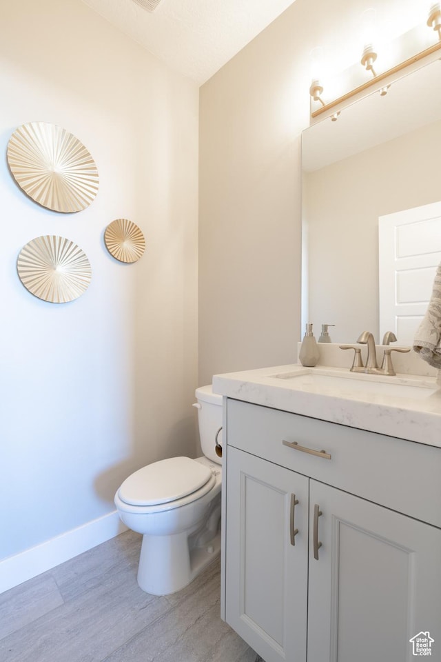 12751 S Harvest Ln W Unit 6, Riverton, UT 84096 - bathroom with baseboards, wood finished floors, toilet, and vanity