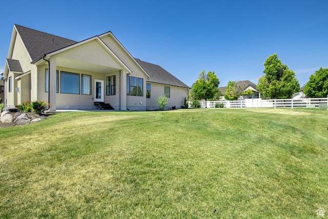 12751 S Harvest Ln W Unit 6, Riverton, UT 84096 - exterior space featuring stucco siding, a shingled roof, fence, and a lawn