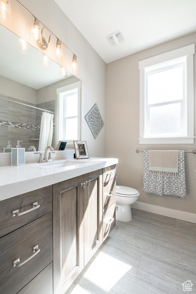 12751 S Harvest Ln W Unit 6, Riverton, UT 84096 - bathroom with toilet, vanity, a tile shower, and visible vents