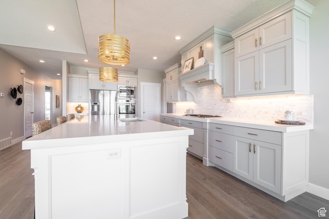 12751 S Harvest Ln W Unit 6, Riverton, UT 84096 - kitchen with decorative backsplash, a sink, appliances with stainless steel finishes, and wood finished floors