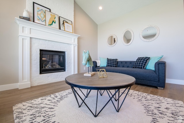 12751 S Harvest Ln W Unit 6, Riverton, UT 84096 - living room featuring wood finished floors, a large fireplace, lofted ceiling, baseboards, and recessed lighting