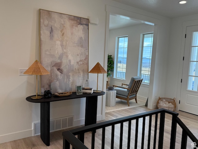 interior space featuring a wealth of natural light, baseboards, and wood finished floors