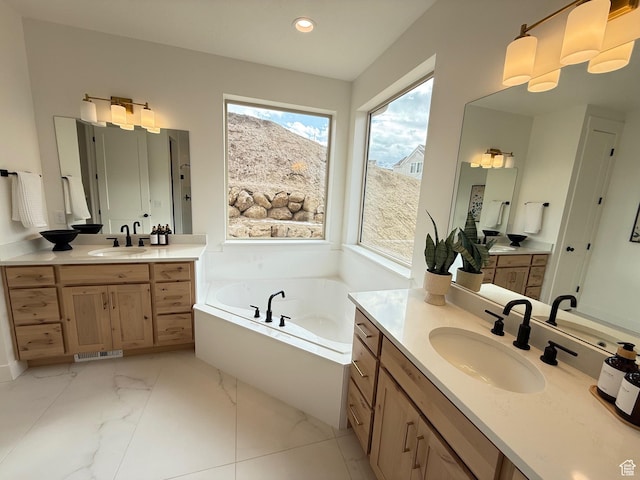full bath with recessed lighting, marble finish floor, a sink, and a bath