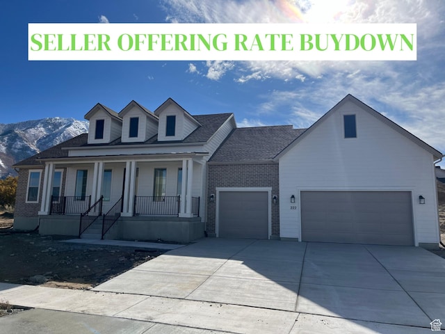 222 E Selman Ridge Dr Unit 19, Salem, UT 84653 - view of front of home featuring a garage, a porch, driveway, a mountain view, and brick siding