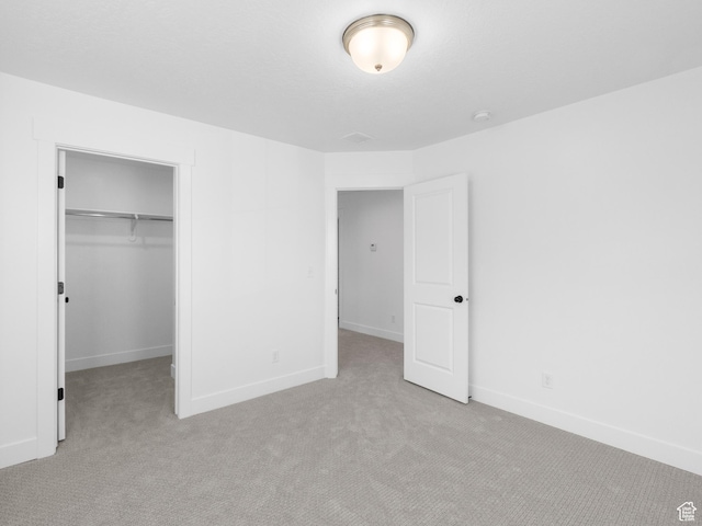1018 S 3250 E Unit 128, Spanish Fork, UT 84660 - unfurnished bedroom featuring a walk in closet, light colored carpet, and a closet